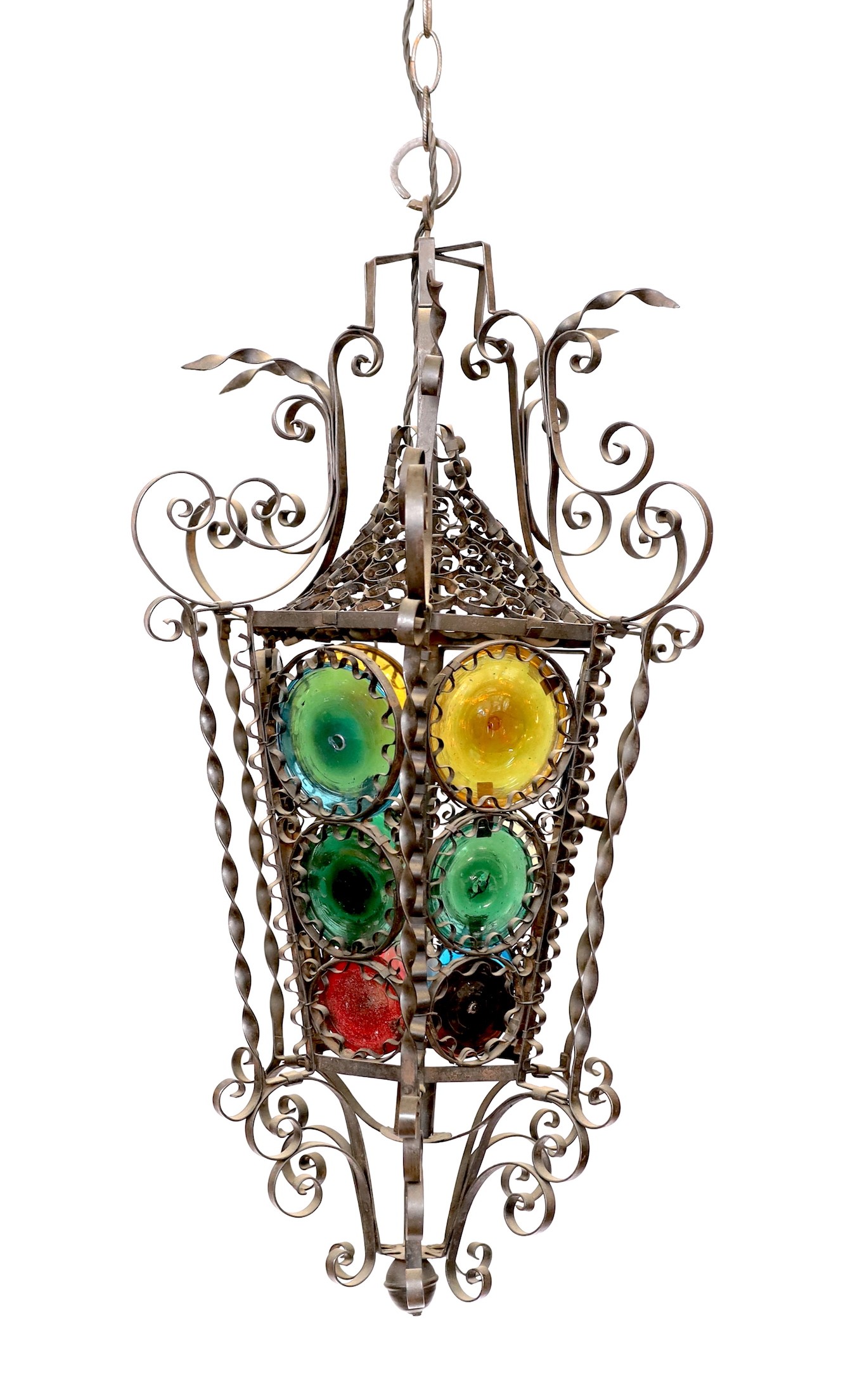 An early 20th century French wrought iron and coloured glass lantern of tapering hexagonal form, height 80cm. width 50cm